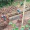 Warga saat gotong royong membersihkan material longsor yang mengancam tiga rumah penduduk di Kampung Cidaun, Desa Sukajaya