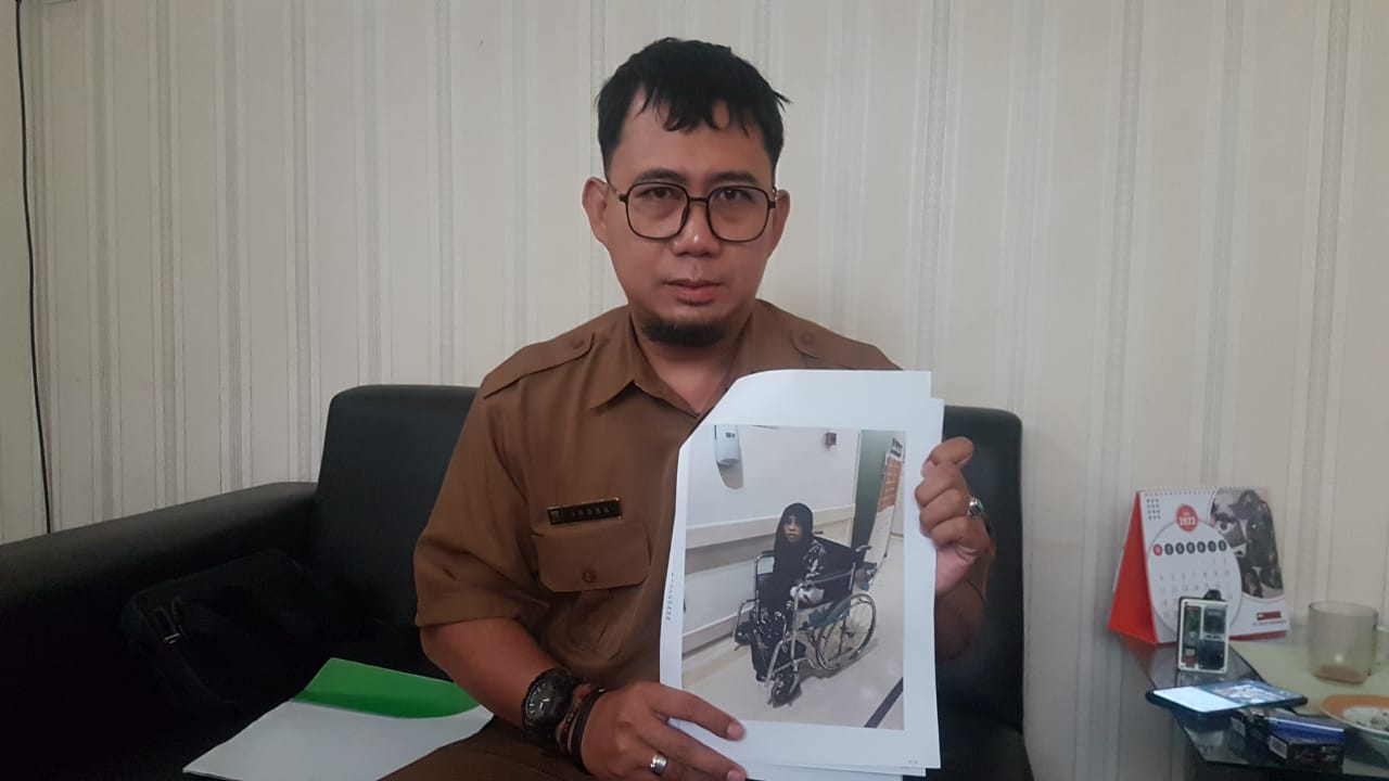PRIHATIN : Petugas Pengelola Data Penempatan Tenaga Kerja pada Disnakertrans Kabupaten Sukabumi, Indra Santika, saat menunjukan foto Lia (33) PMI asal Jampangtengah yang disiram majikannya di Saudi Arabia.(FOTO : DENDI/|RADAR SUKABUMI)
