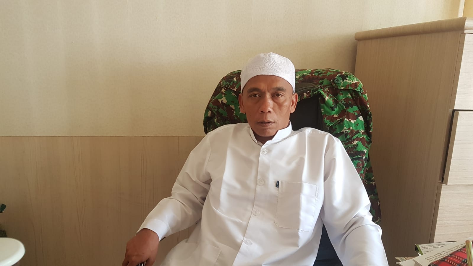 DIWAWANCARAI : Ketua II PPIH Kabupaten Sukabumi, KH. Ujang Hamdun saat diwawancarai Radar Sukabumi, soal biaya jamaah haji tahun 2023.(FOTO : DENDI/RADAR SUKABUMI)