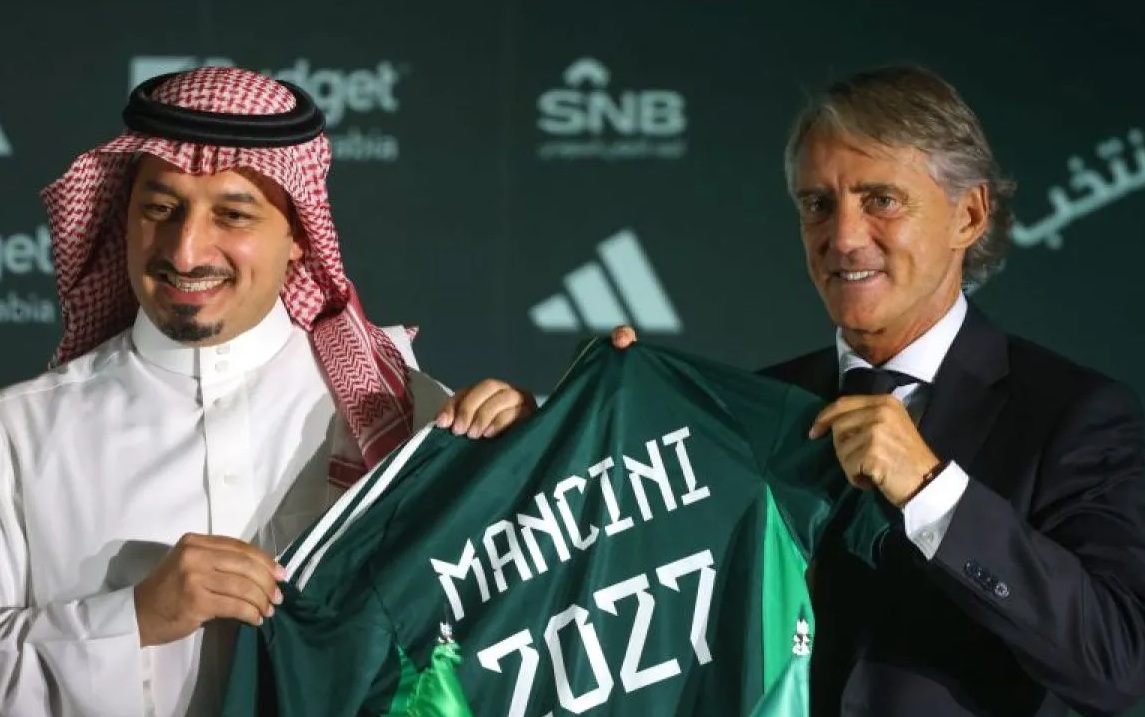 Presiden Federasi Sepak Bola Arab Saudi Yasser al-Misehal (kiri) dan pelatih baru timnas Arab Saudi Roberto Mancini (kanan) berpose untuk difoto pada konferensi pers dan penandatanganan kontrak kerja di Riyadh, Arab Saudi, Senin (28/8/2023). (AFP/FAYEZ NURELDINE).