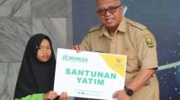 Bupati Sukabumi Marwan Hamami saat menyerahkan santunan untuk anak yatim melalui Program Bebeza Baznas Kabupaten Sukabumi pada Senin, (7/8).