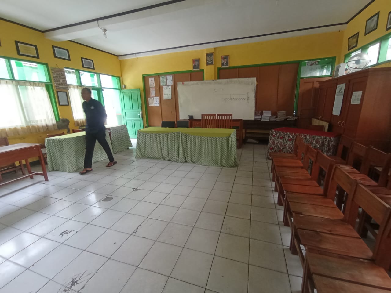 MENINJAU : Salah seorang petugas saat meninjau sekolah yang dijadikan TPS untuk Pemilu 2024. (foto : Widi Radar Sukabumi)