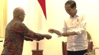Presiden Joko Widodo (kanan) menerima undangan pemungutan suara Pemilu 2024 dari Ketua KPPS TPS 10 Gambir Hamdy Basjar (kiri) di Istana Merdeka, Jakarta, pada Senin (12/2/2024). (Yashinta Difa)