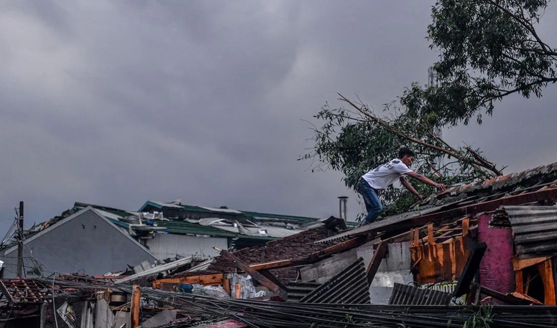 Warga memeriksa atap rumanya yang rusak pascaputing beliung yang terjadi di Rancaekek, Kabupaten Bandung, Jawa Barat, Rabu (21/2/2024). (Raisan Al Farisi)