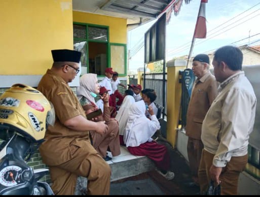 DITANGANI : Pemerintah Desa Sukajaya, saat mengevakuasi sejumlah siswa SDN Nangewer, Desa Sukajaya, Kecamatan/Kabupaten Sukabumi, ke Puskesmas Karawang yang diduga mengalami keracunan jajanan makanan.(Foto : ist)