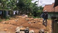 KECEWA : Salah seorang warga saat menunjukan pembangunan pondasi untuk hunian tetap yang diberhentikan bagi penyintas bencana retakan tanah di Kampung Jati, Desa Mekarsari, Kecamatan Nyalindung, Kabupaten Sukabumi.(FOTO : DENDI/RADAR SUKABUMI)
