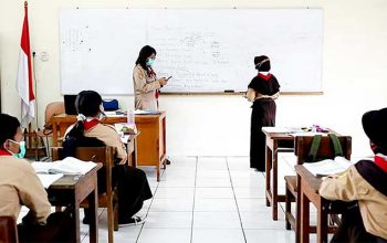 Guru mengajar di ruang kelas