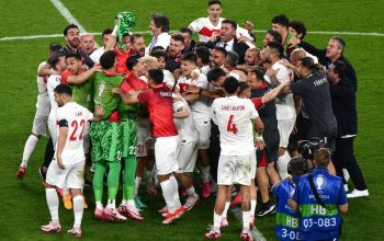 Para pemain timnas Turki merayakan kelolosan mereka ke babak knock-out Euro 2024 setelah memenangkan pertandingan terakhir Grup F melawan Republik Ceko di Volksparkstadion, Hamburg, pada 26 Juni 2024. (AFP/Christophe Simon)