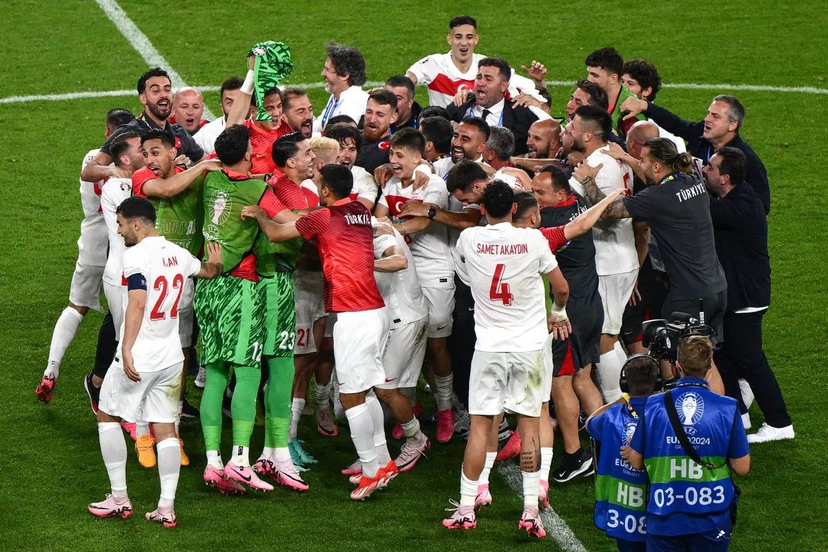 Para pemain timnas Turki merayakan kelolosan mereka ke babak knock-out Euro 2024 setelah memenangkan pertandingan terakhir Grup F melawan Republik Ceko di Volksparkstadion, Hamburg, pada 26 Juni 2024. (AFP/Christophe Simon)