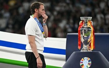 Pelatih timnas Inggris Gareth Southgate berjalan melewati trofi Piala Eropa setelah usainya pertandingan final Euro 2024 antara Spanyol dan Inggris di Stadion Olimpiade, Berlin, pada 14 Juli 2024. (AFP/Javier Soriano)