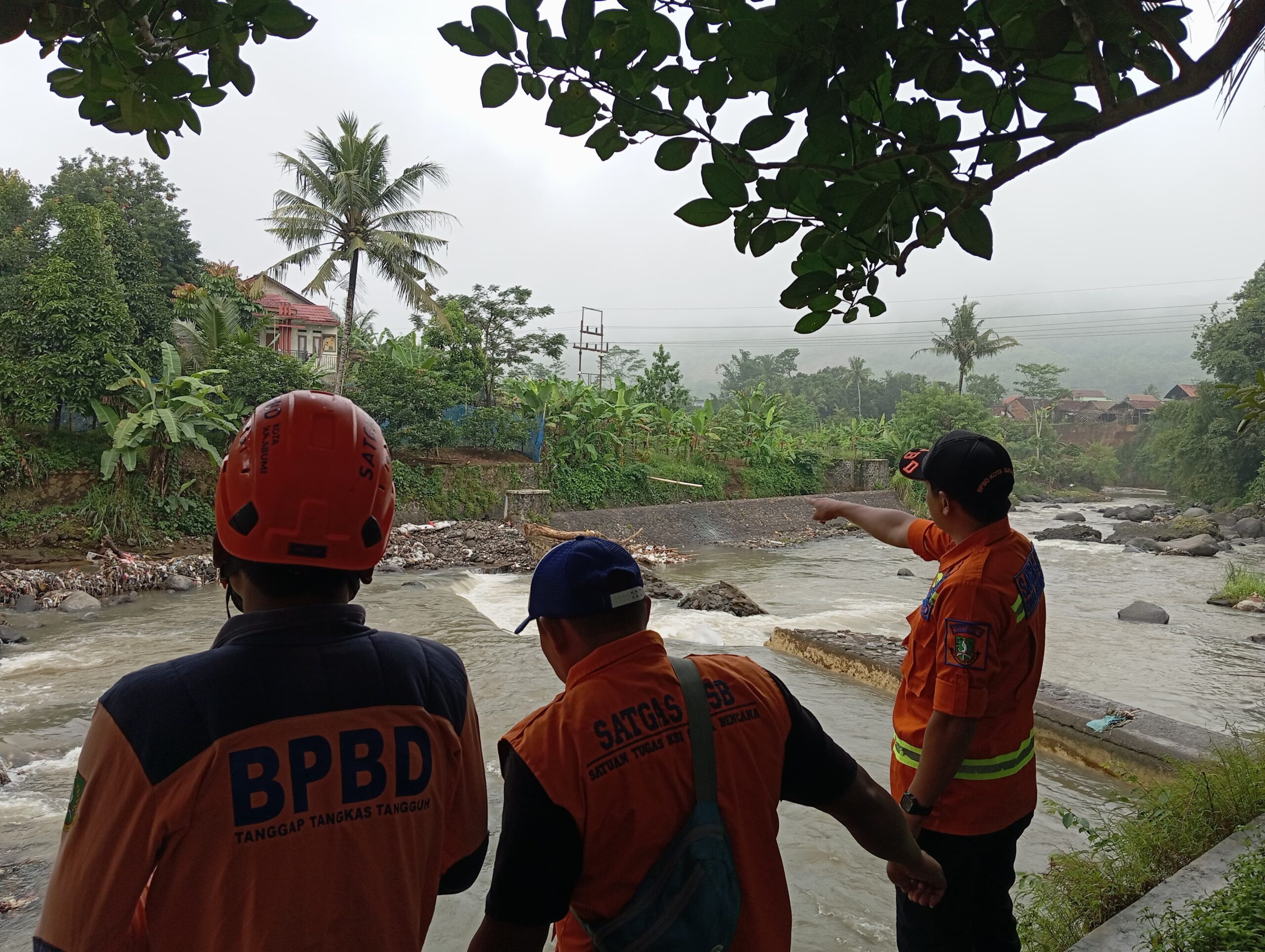 PENINJAUAN: Sejumlah personel BPBD Kota Sukabumi saat melakukan peninjauan bendungan jebol di irigasi Sungai Cipelang, Kampung Warung Kalapa RT1/RW1 Kelurahan/Kecamatan Lembursitu, Senin (20/1). (FT: IST)