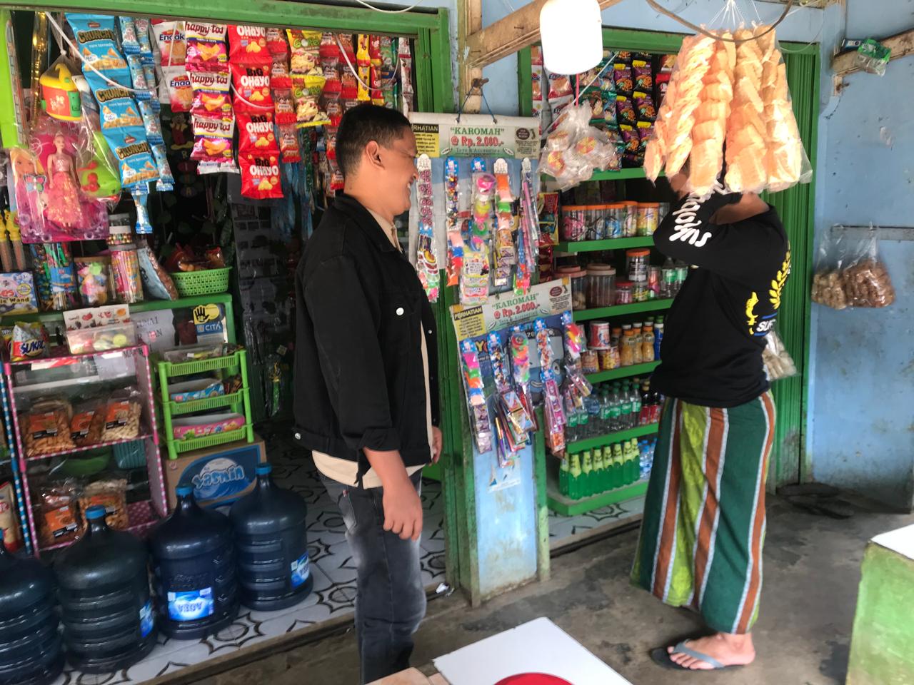 EDUKASI : Kades Cibolang, Arif Agung Gumelar, saat memberikan edukasi kepada pemilik warung untuk tidak menjual lotre kepada anak-anak. (FOTO : UNTUK RADAR SUKABUMI)