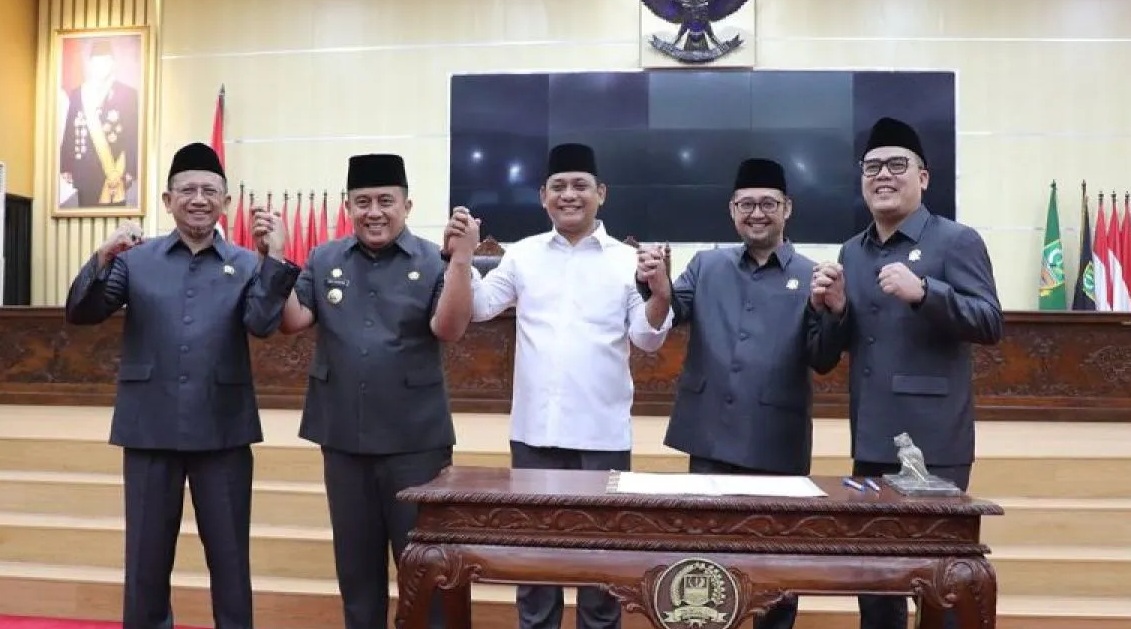 Penjabat Bupati Bekasi Dedy Supriyadi (kedua dari kiri) bergandengan tangan bersama Wakil Bupati Bekasi terpilih Asep Surya Atmaja (tengah) serta unsur pimpinan legislatif usai agenda paripurna penetapan pasangan calon pemenang Pilkada 2024 di Gedung DPRD setempat, Senin. (Pradita Kurniawan Syah)