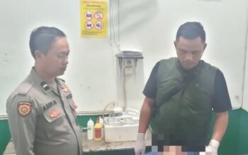 Petugas Polsek Sindangbarang, Cianjur, Jawa Barat, membawa jasad korban anak jalanan yang diduga tewas setelah meminum miras oplosan alkohol murni 70 persen bersama lima orang temannya, ke Puskesmas Sindangbarang, Kamis (13/2/2025). (Ahmad Fikri)