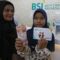 Seorang pelajar didampingi orangtuanya memperlihatkan uang tunai bantuan dana Program Indonesia Pintar (PIP) usai pencairan di Bank Syariah Indonesia (BSI) di Banda Aceh, Aceh, Rabu (3/4/2024). (Khalis Surry)