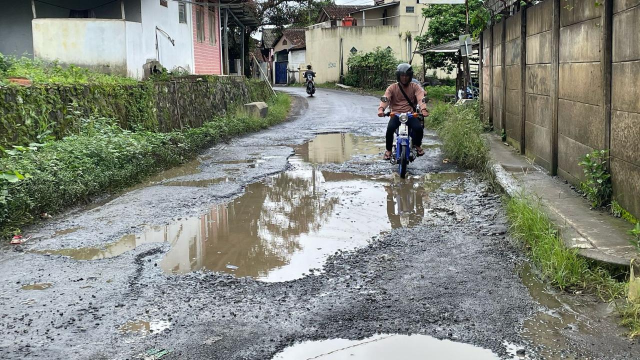 RUSAK PARAH : Kondisi ruas Jalan Raya Babakan Sawah - Cileuleuy, Ambarjaya, Kecamatan Ciambar, Kabupaten Sukabumi, dipenuhi kubangan air pada Senin (21/04).