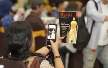 Masyarakat melihat dan memfoto cover majalah Mangle. (Unpad)