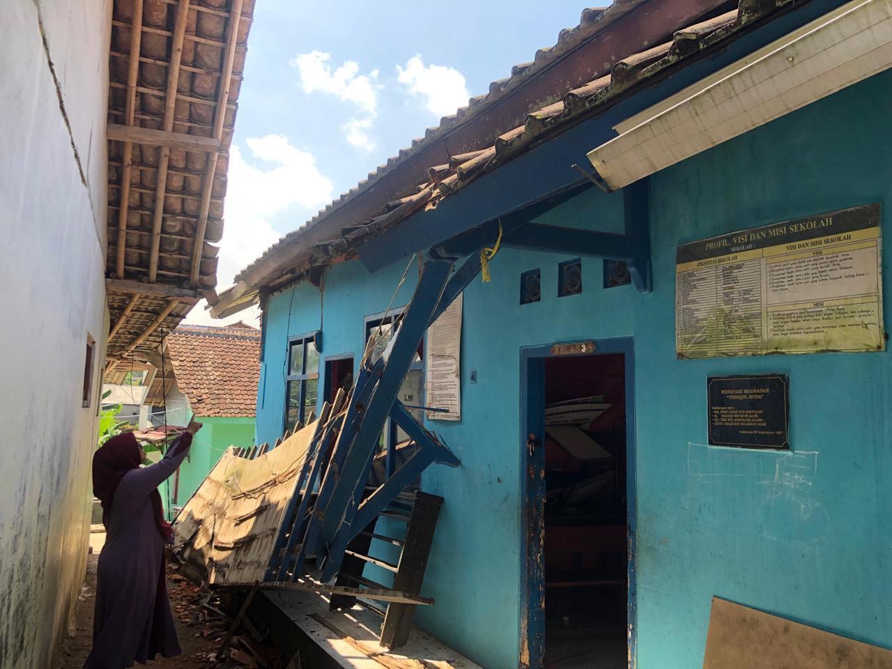 FOTO : DENDI/RADAR SUKABUMI AMBRUK : Salah seorang guru MD Nurul Hikmah di Kampung Ciburial, RT 58/RW 11, Desa Gunungguruh, Kecamatan Gunungguruh, Kabupaten Sukabumi, saat menunjukan lokasi atap sekolah yang ambruk, akibat lapuk.