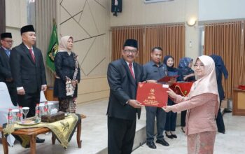Bupati Sukabumi Asep Japar saat menyerahkan penghargaan kepada PNS.(FOTO: NANDI / RADARSUKABUMI)