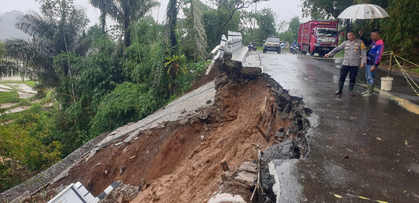 Tembok Penahan Tanah (TPT) Jabar Istimewa di ruas Jalan Raya Provinsi Sukabumi–Sagaranten, tepatnya di Kampung Langkob, Desa Nyalindung, Kecamatan Nyalindung, kembali ambruk setelah diterjang longsor pada Minggu (11/2/2026) pagi.