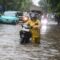 Warga mendorong motornya yang mogok saat melintasi banjir di kawasan Sunter, Jakarta, Senin (12/1/2026).(Muhammad Adimaja)